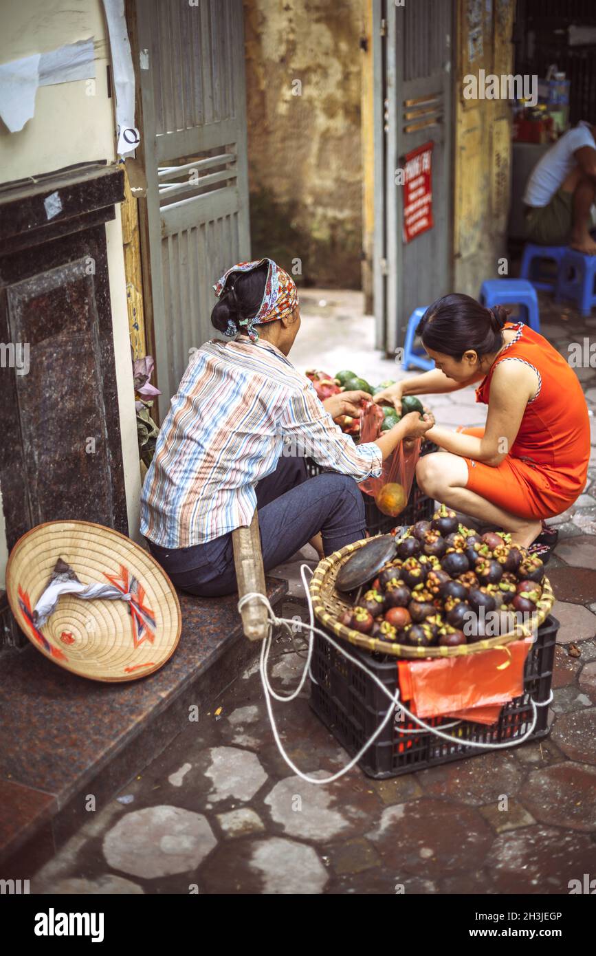 Hanoi, Vietnam - May 2, 2015: Vietnamese street market seller, on May 2, 2015, in Hanoi, Vietnam Stock Photo