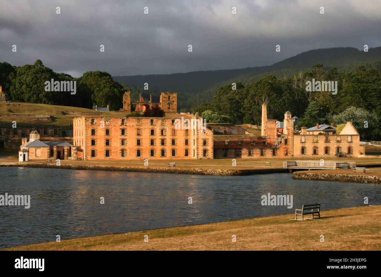 Convict penitentiary soon after sunrise with dark clouds at Port Arthur penal colony, Tasmania, Australia Stock Photo
