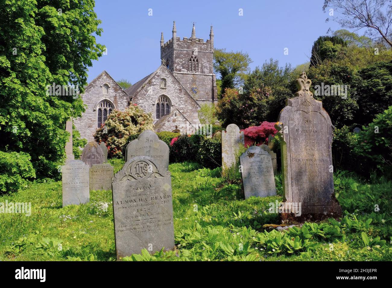 Veryan parish Church of St Symphorian with gravestones and flowers in Veryan, Cornwall, England Stock Photo