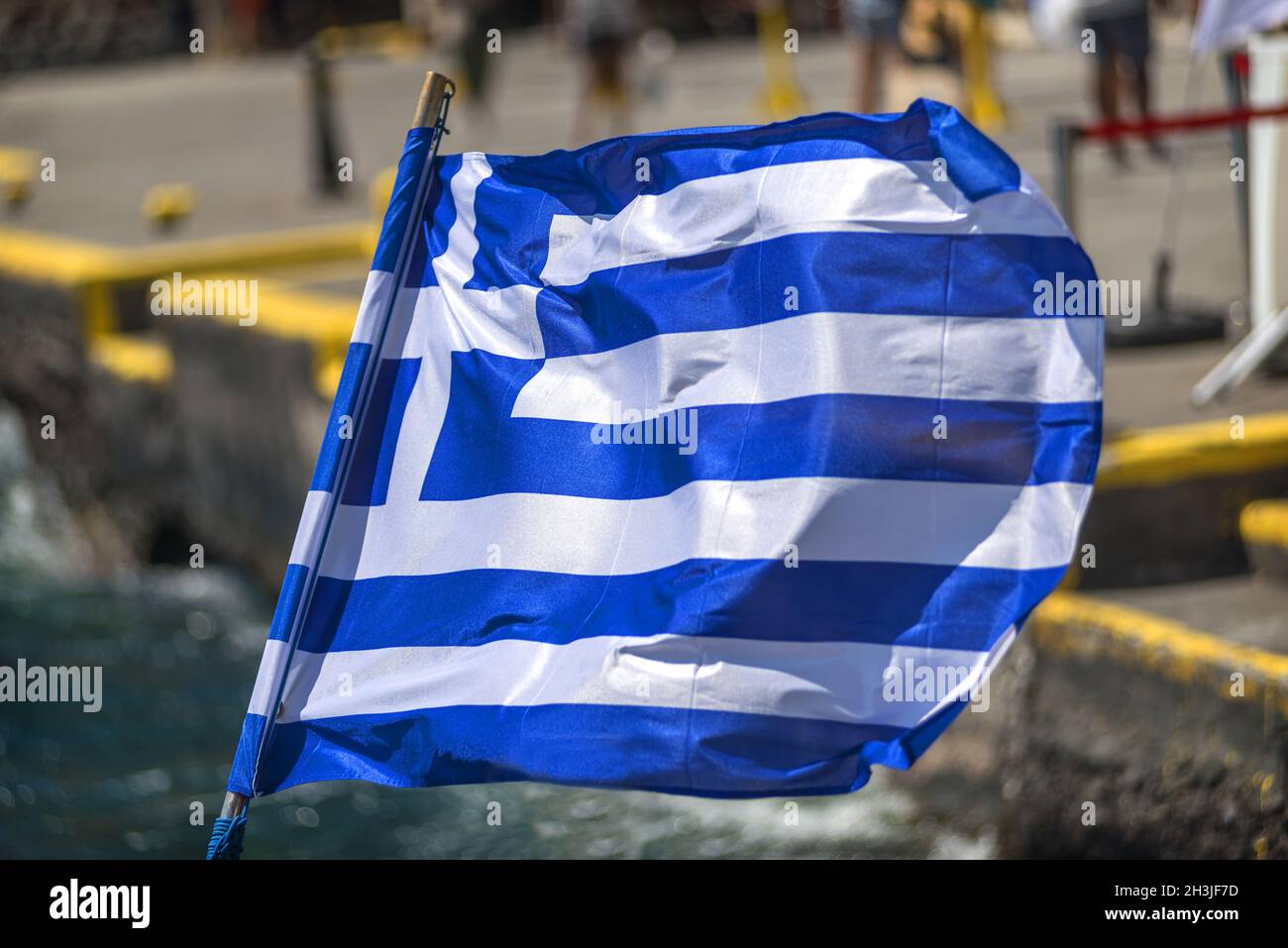 Greek flag in a Touristic ship in Santorini, Greece Stock Photo