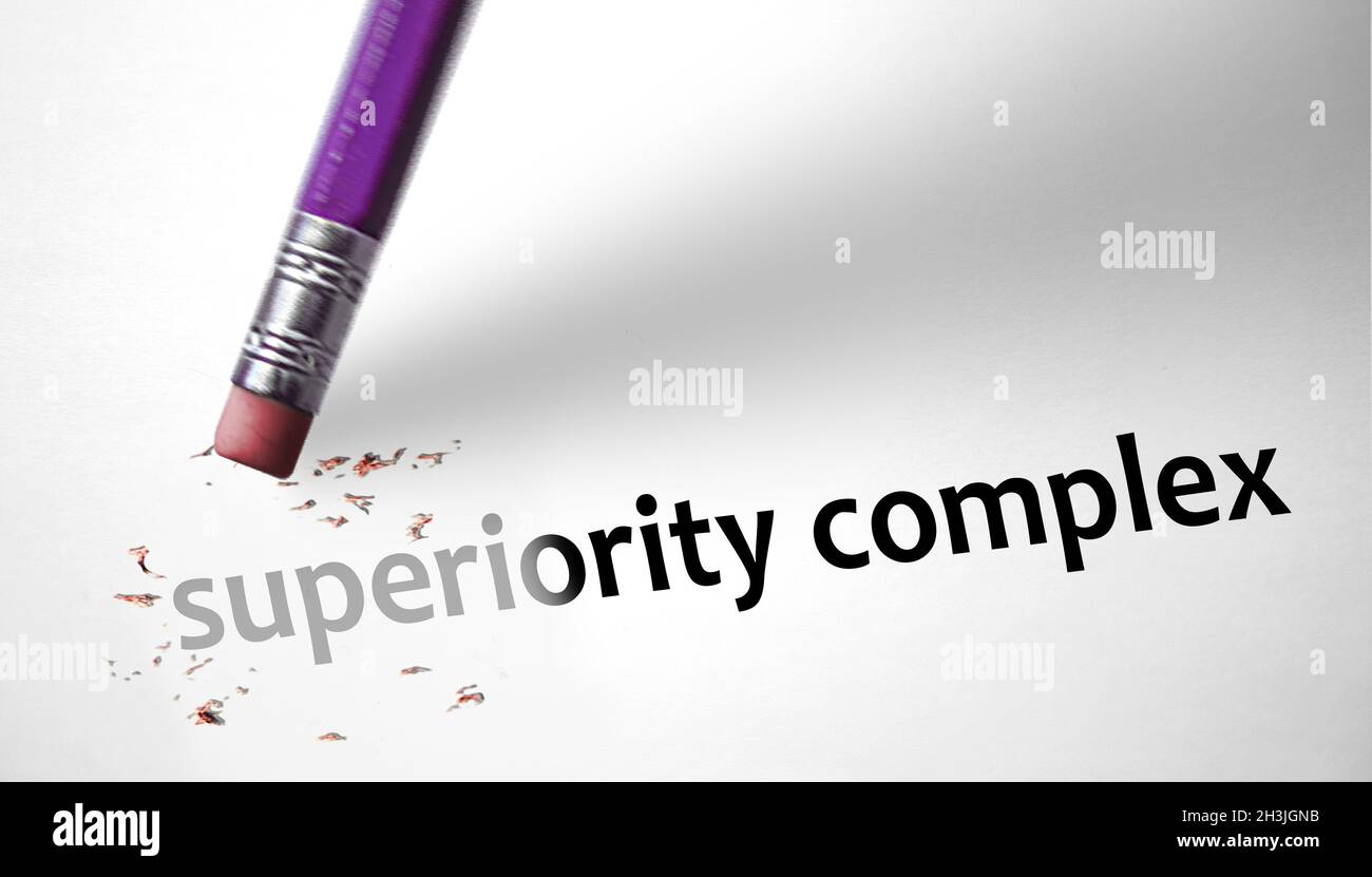 Eraser deleting the concept Superiority Complex Stock Photo