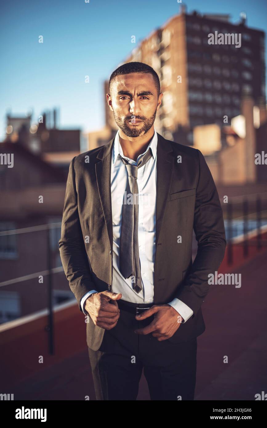 Confident attractive Arab businessman in urban environment Stock Photo