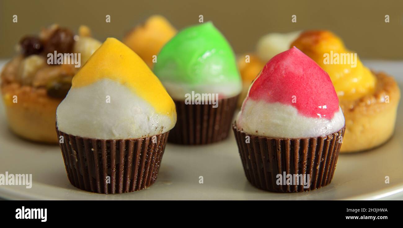 Variety of muffin type fairy cakes, cup cakes and fresh fruit cakes Stock Photo