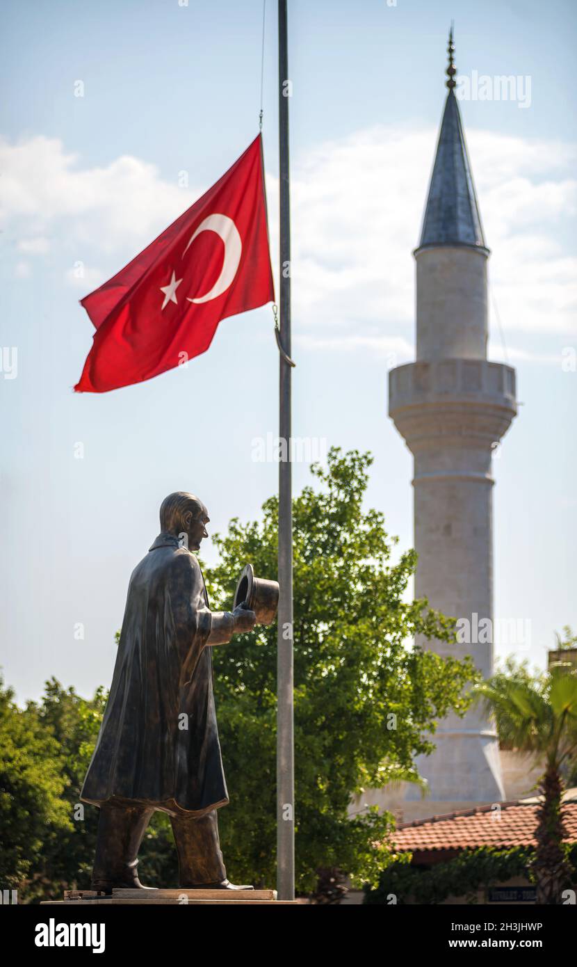 Turkish Flag, Mosque and a statue of Mustafa Kemal Ataturk at Dalyan Kaunos, Turkey Stock Photo