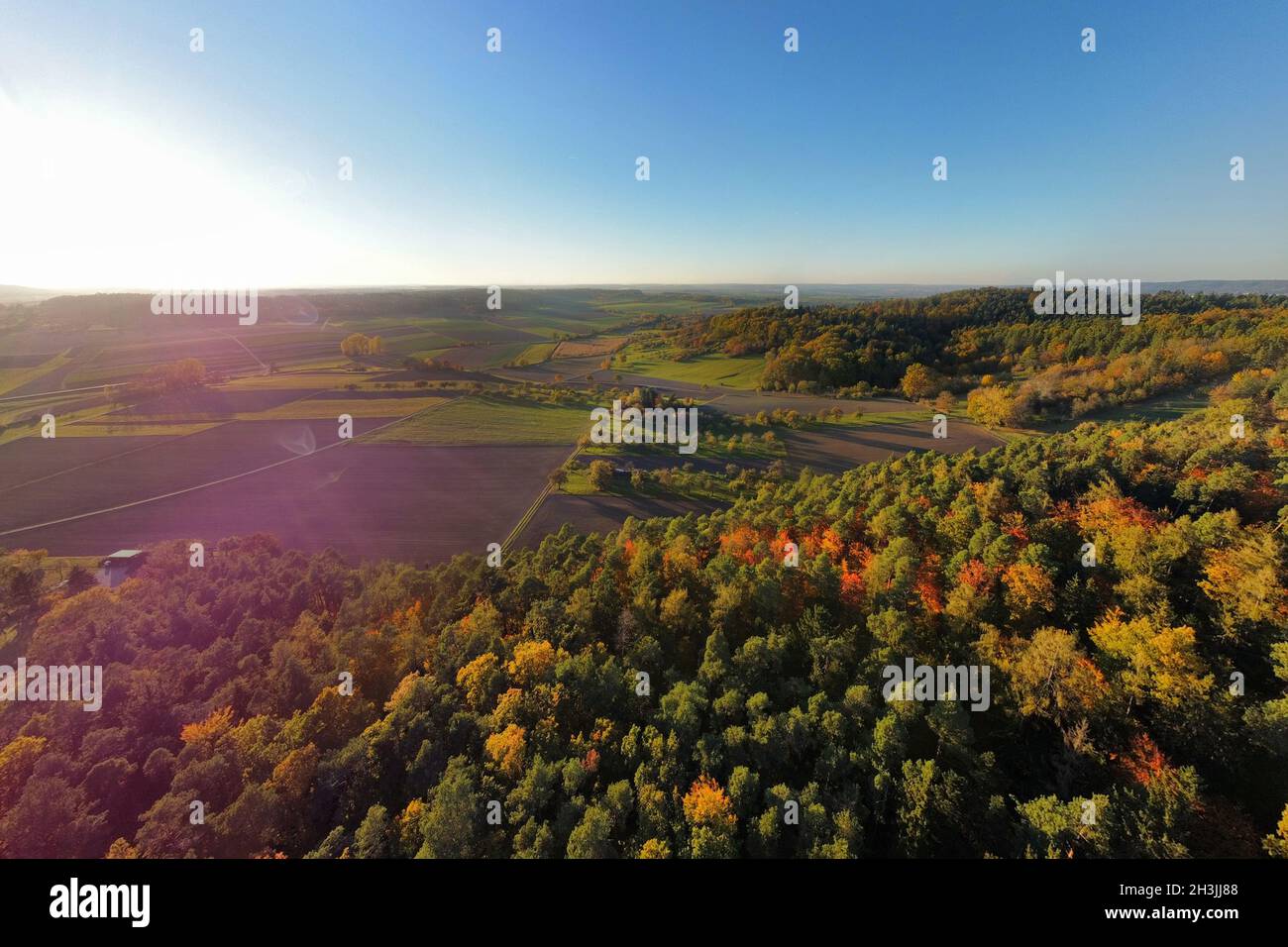 Aerial image of beautiful colourful autumnal forest and valley at sunset Stock Photo