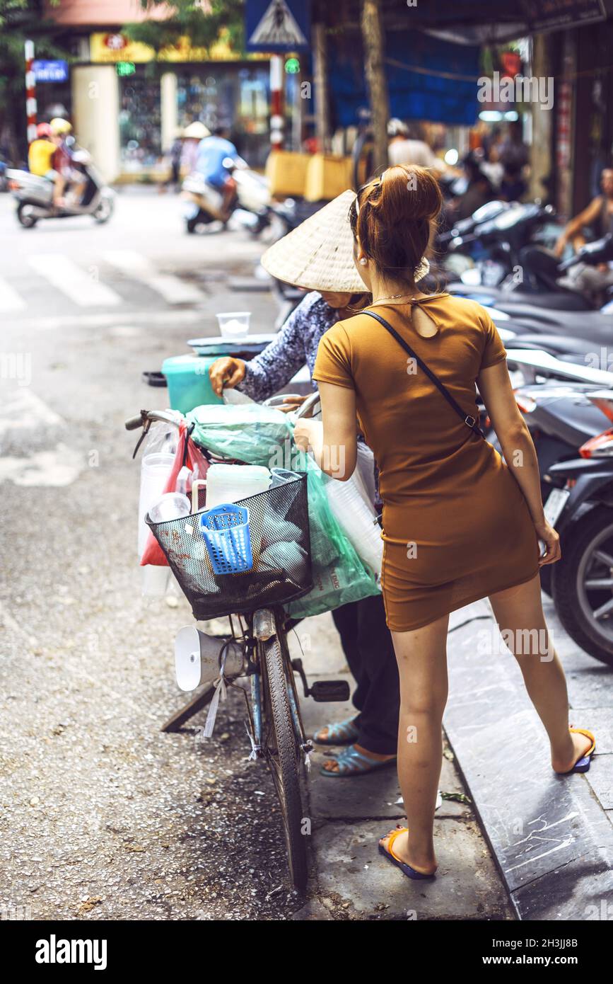Hanoi, Vietnam - May 2, 2015: Vietnamese street market seller, on May 2, 2015, in Hanoi, Vietnam Stock Photo