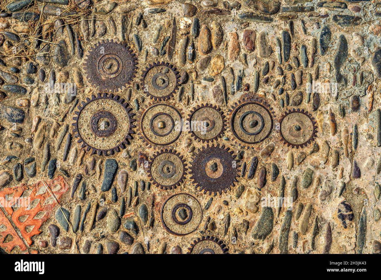 Pavement texture with gears and bricks in Montjuic, Barcelona, Spain Stock Photo