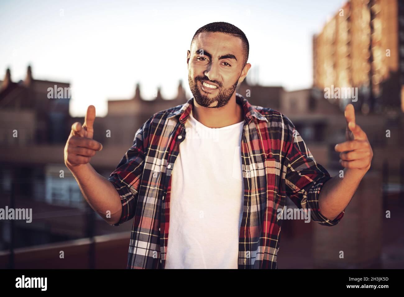 Good looking young arab man in casual clothes in urban environment Stock Photo