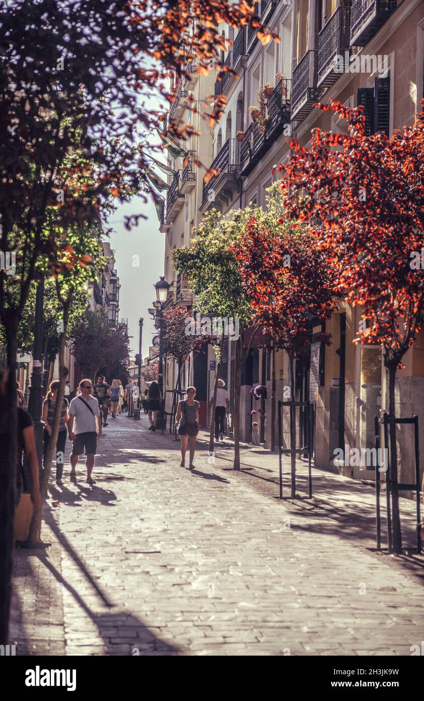 MADRID, SPAIN - APRIL 26: Old narrow street with few cafe in April 26, 2013 in Madrid, Spain. It is old centre of capital city Stock Photo