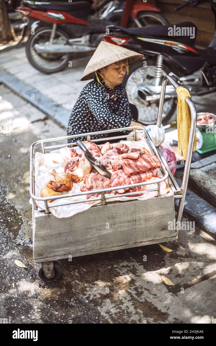 Hanoi, Vietnam - May 2, 2015: Vietnamese street market lady seller, on May 2, 2015, in Hanoi, Vietnam Stock Photo