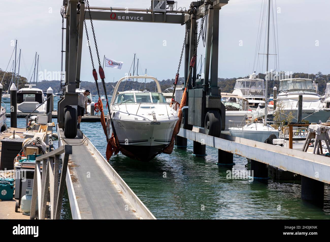Cruiser boat being lifted into the water from a marina lift hoist, Church Point,Sydney,Australia
