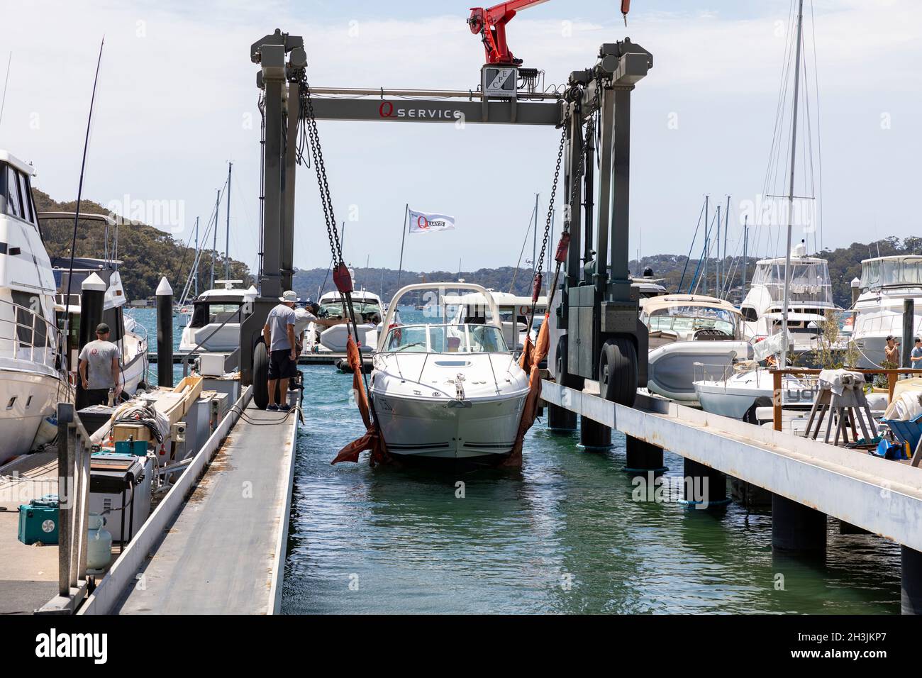 Cruiser boat being lifted into the water from a marina lift hoist, Church Point,Sydney,Australia