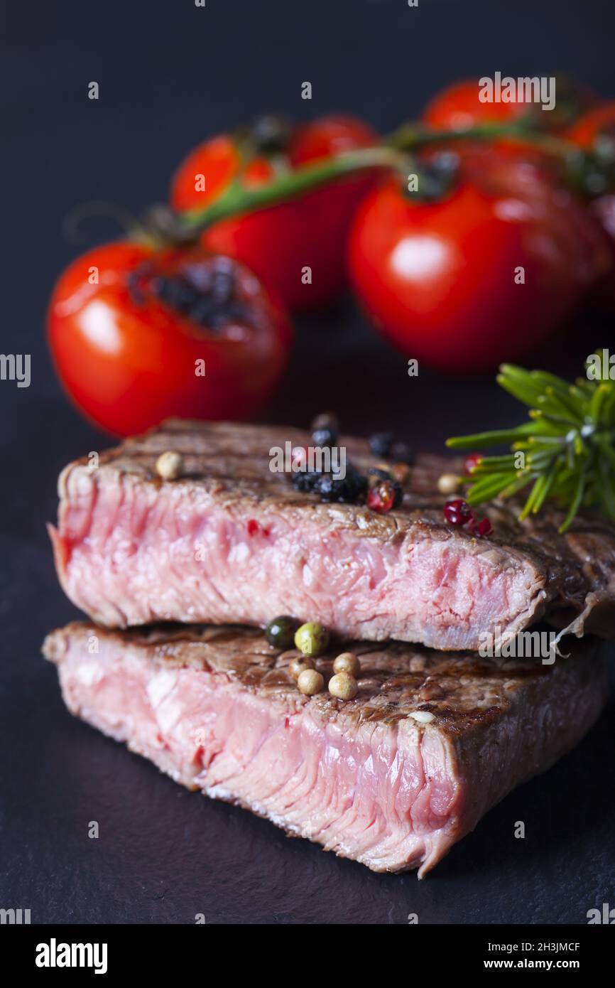 Juicy cut steak on a slate plate Stock Photo