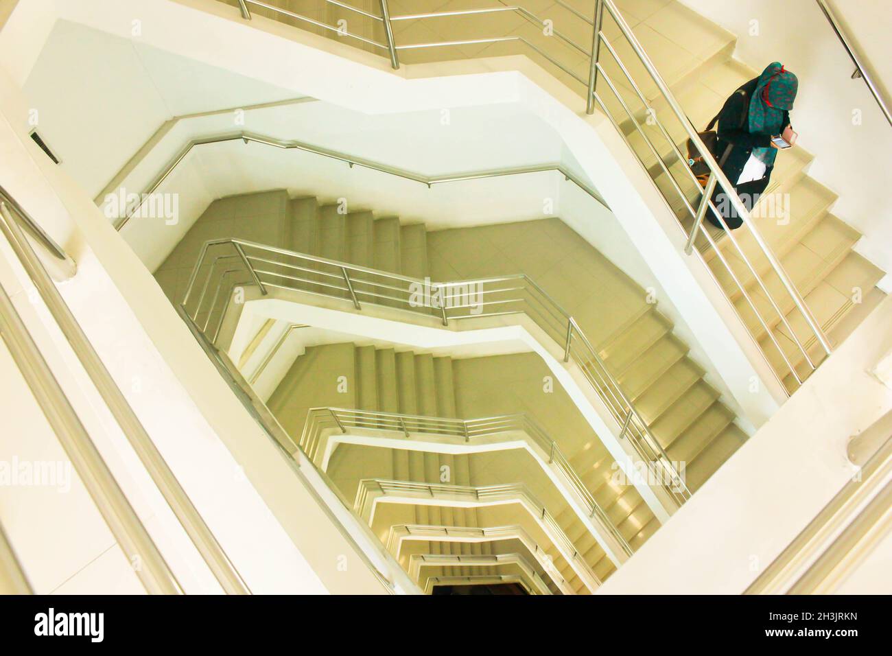 a woman descending from stairs Stock Photo