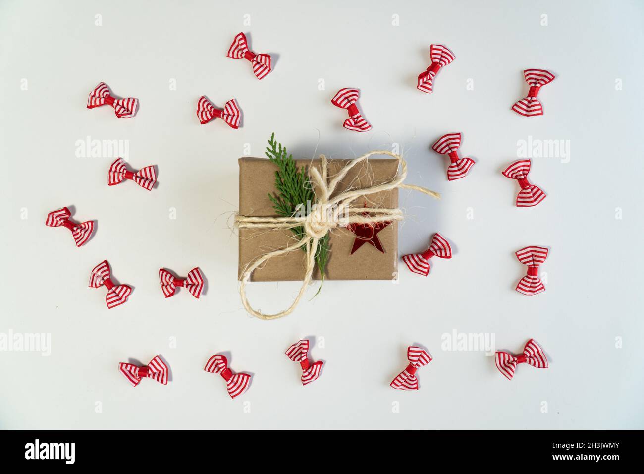 Noel gift box with red white noel ribbon on isolated white background top view photo Stock Photo