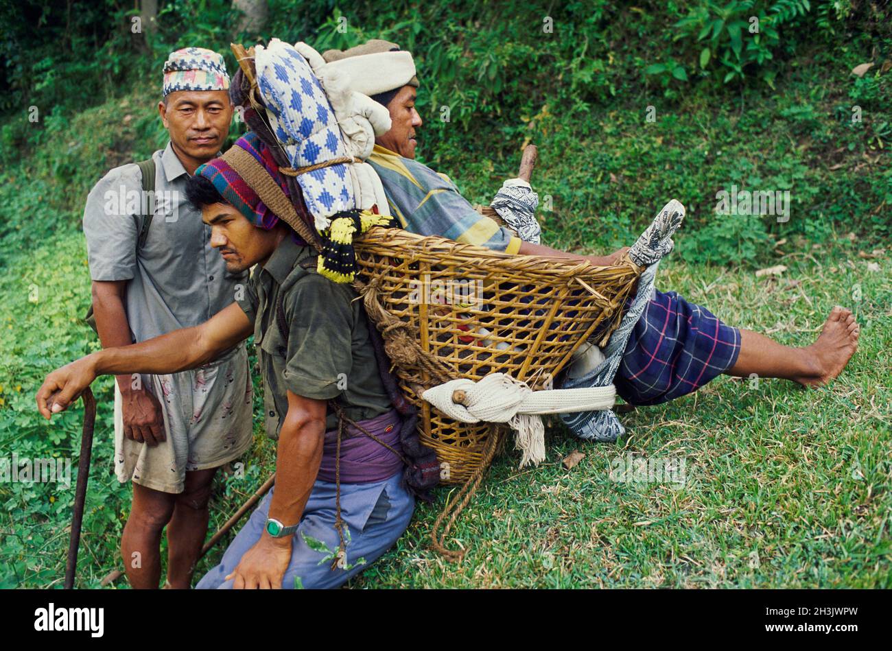 Nepal, Porter of Himalaya, Sick person on the way to hospital after 2 days walk. Stock Photo