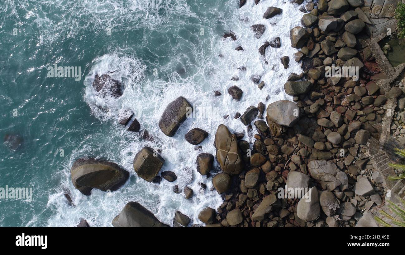 Aerial top view of sea waves hitting rocks on the beach in Phuket Stock ...