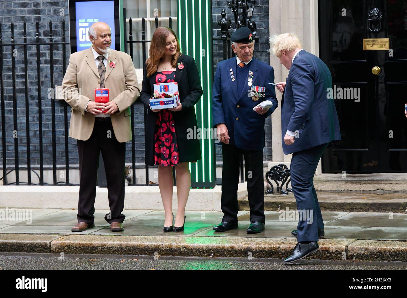 London, UK. 29th Oct, 2021. Prime Minister Boris Johnson meets with fundraisers for the Royal British Legion and purchases a poppy in front of Number 10 Downing Street, London Credit: Alan D West/Alamy Live News Stock Photo