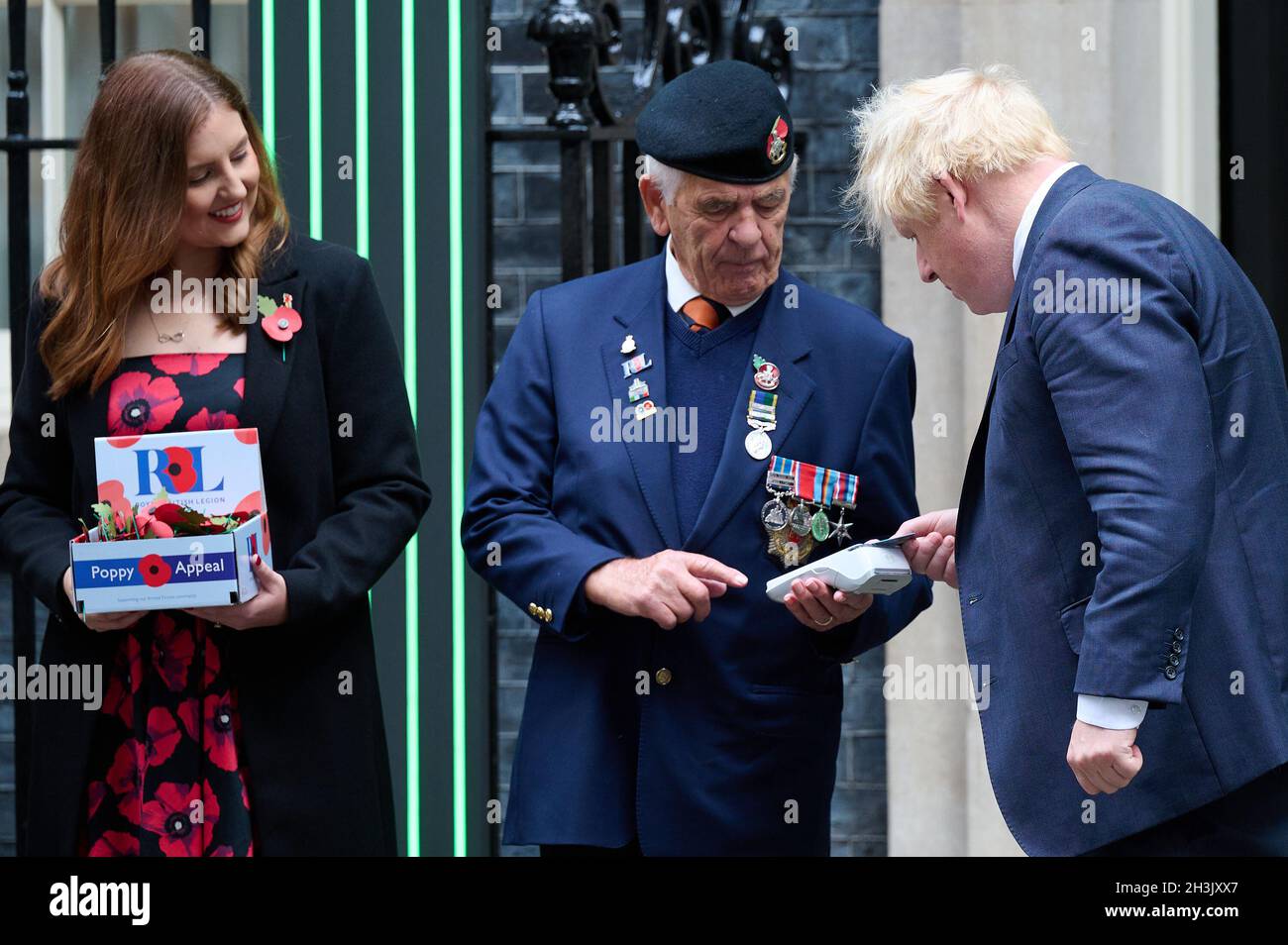 London, UK. 29th Oct, 2021. Prime Minister Boris Johnson meets with fundraisers for the Royal British Legion and purchases a poppy in front of Number 10 Downing Street, London Credit: Alan D West/Alamy Live News Stock Photo