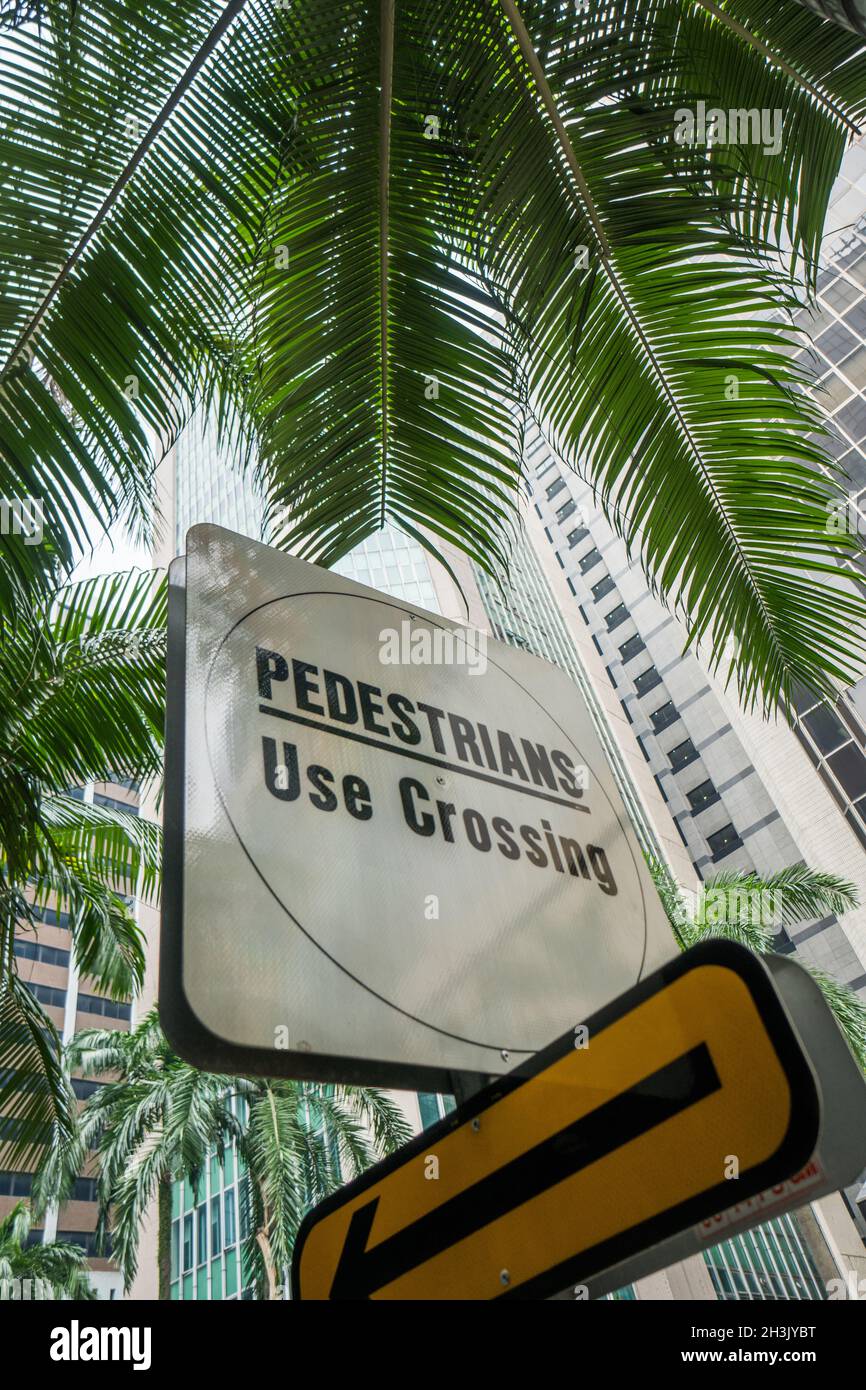Pedestrians crossing street sign in exotic city Stock Photo - Alamy