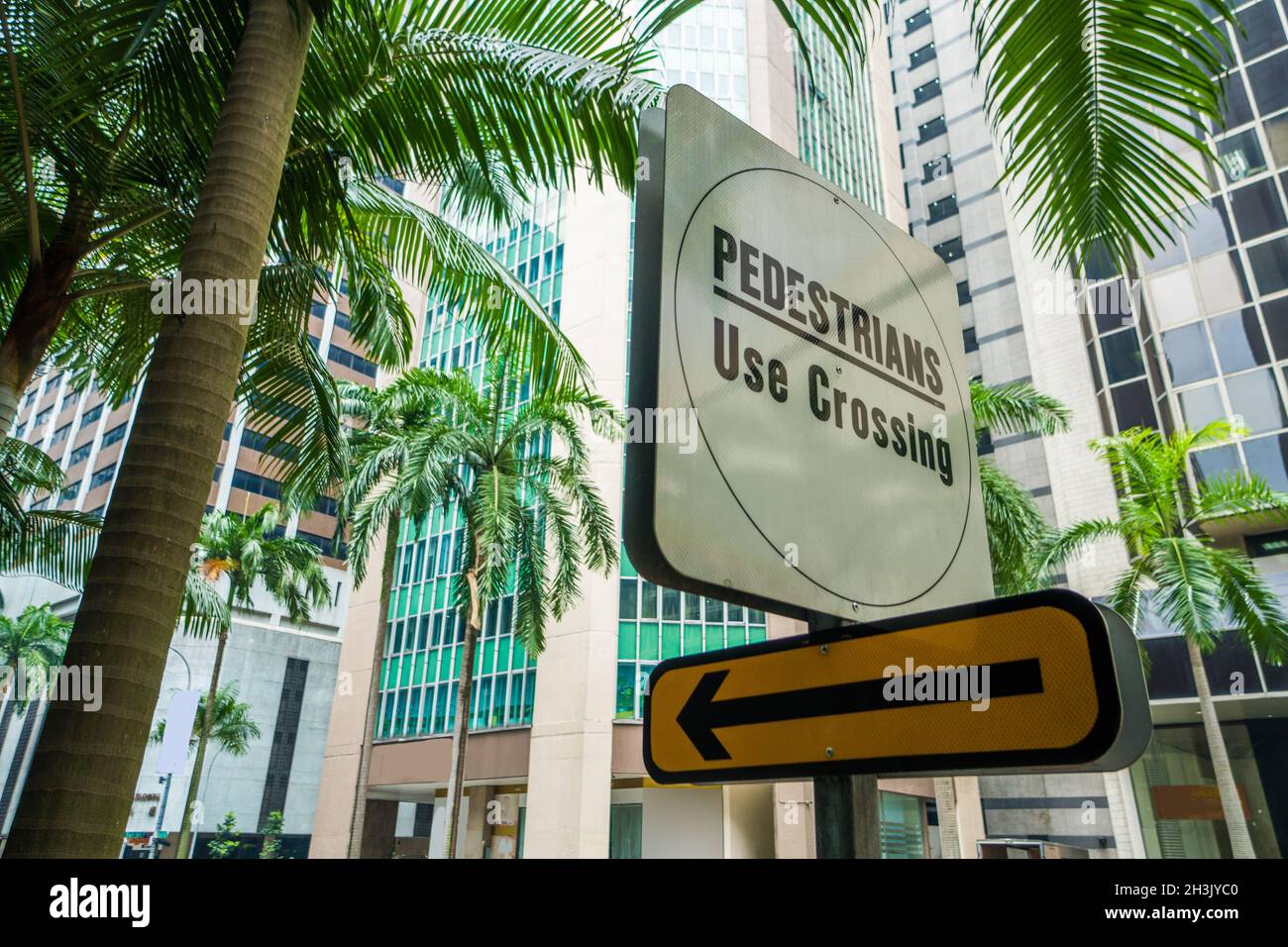 Pedestrians crossing street sign in exotic city Stock Photo - Alamy