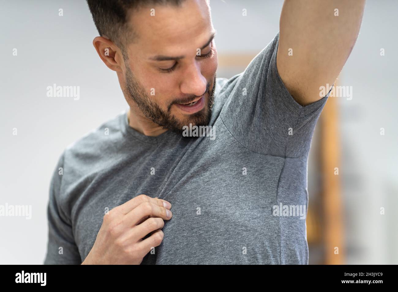 Athlete Using Antiperspirant Deodorant Against Hyperhidrosis Sweating Stock Photo