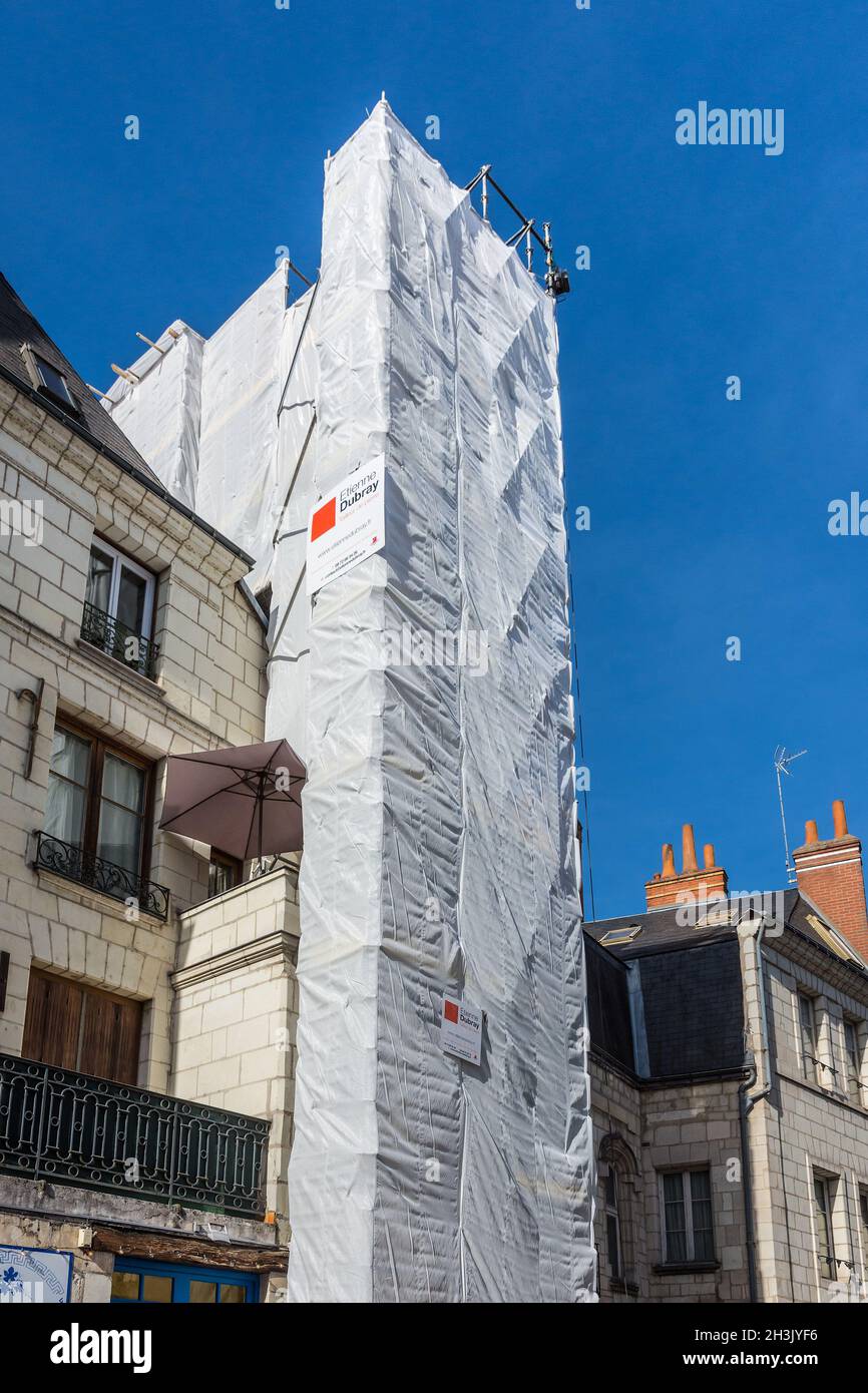 Protective sheeting and scaffolding covering tall building being renovated in Tours, Indre-et-Loire (37), France. Stock Photo
