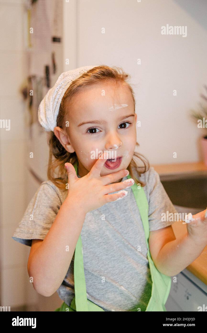 Socking Cook Girl sucking her finger while cooking, with flour in her face Stock ...