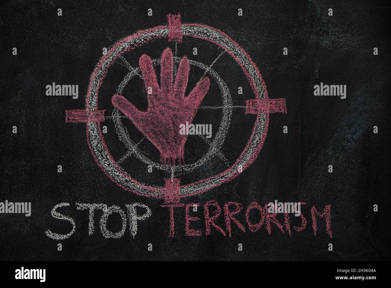 Red hand shape and stop terrorism text in the sign target on black