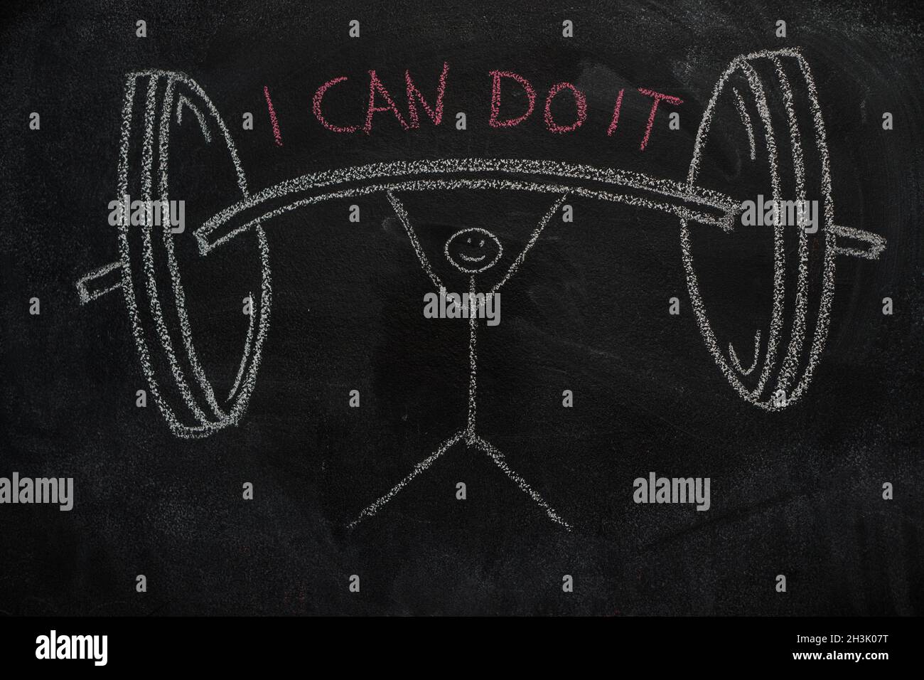Symbol of human with barbell and I can do it text on black chalkboard Stock Photo