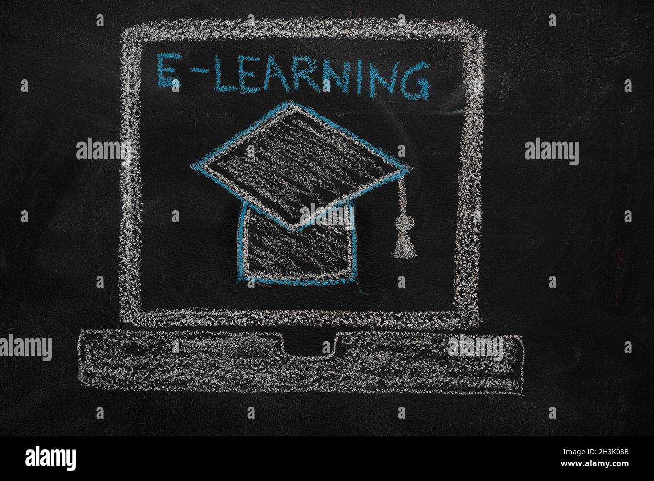 E-learning education icon on black chalkboard Stock Photo