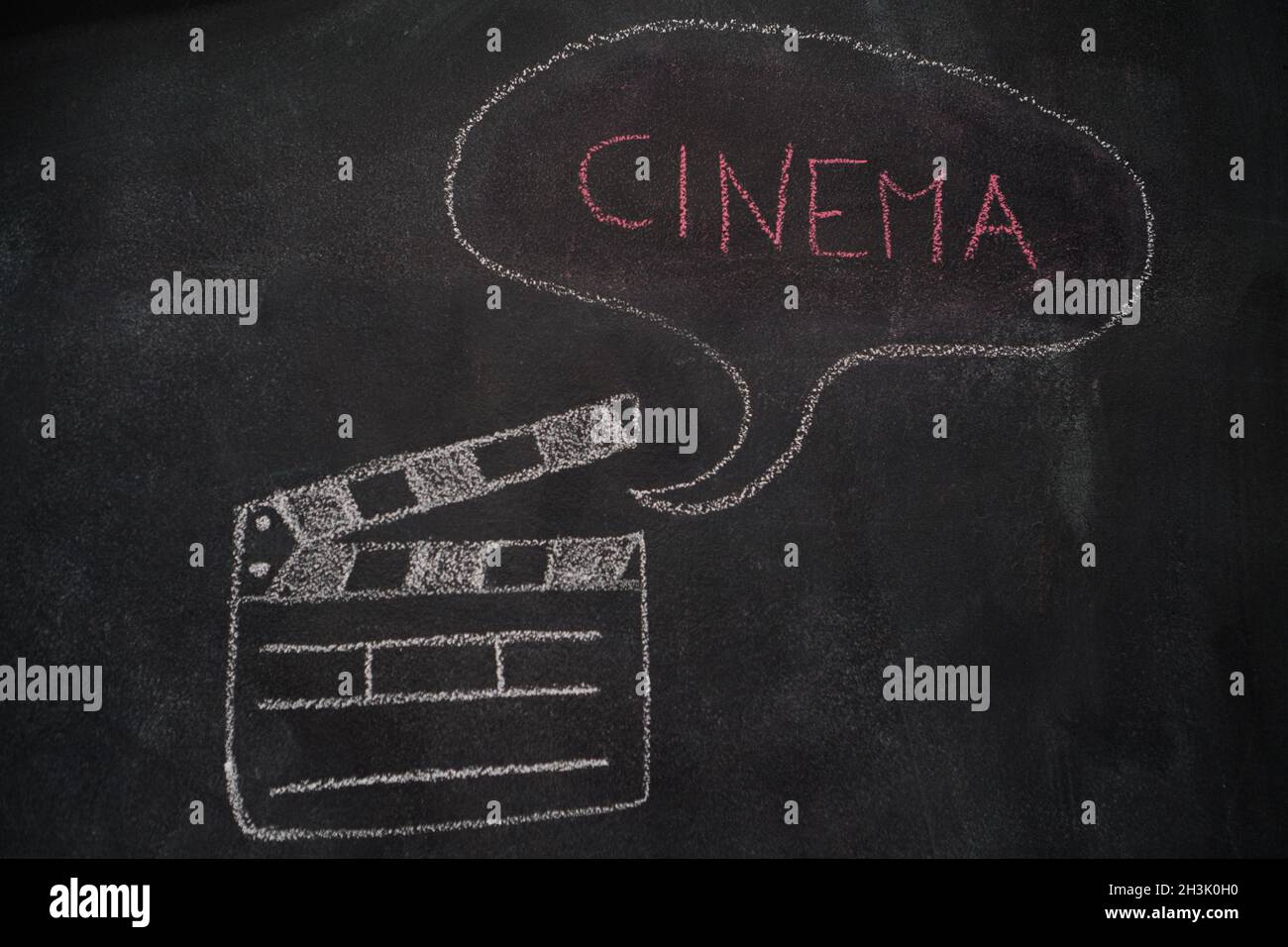 Movie clapper with speech bubble on chalkboard Stock Photo