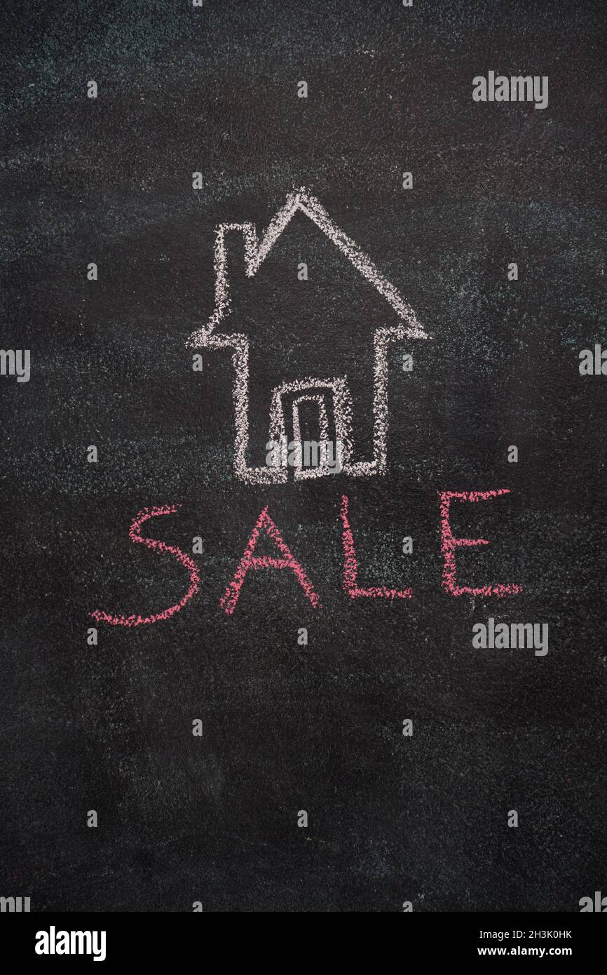House with sale word on black chalkboard Stock Photo