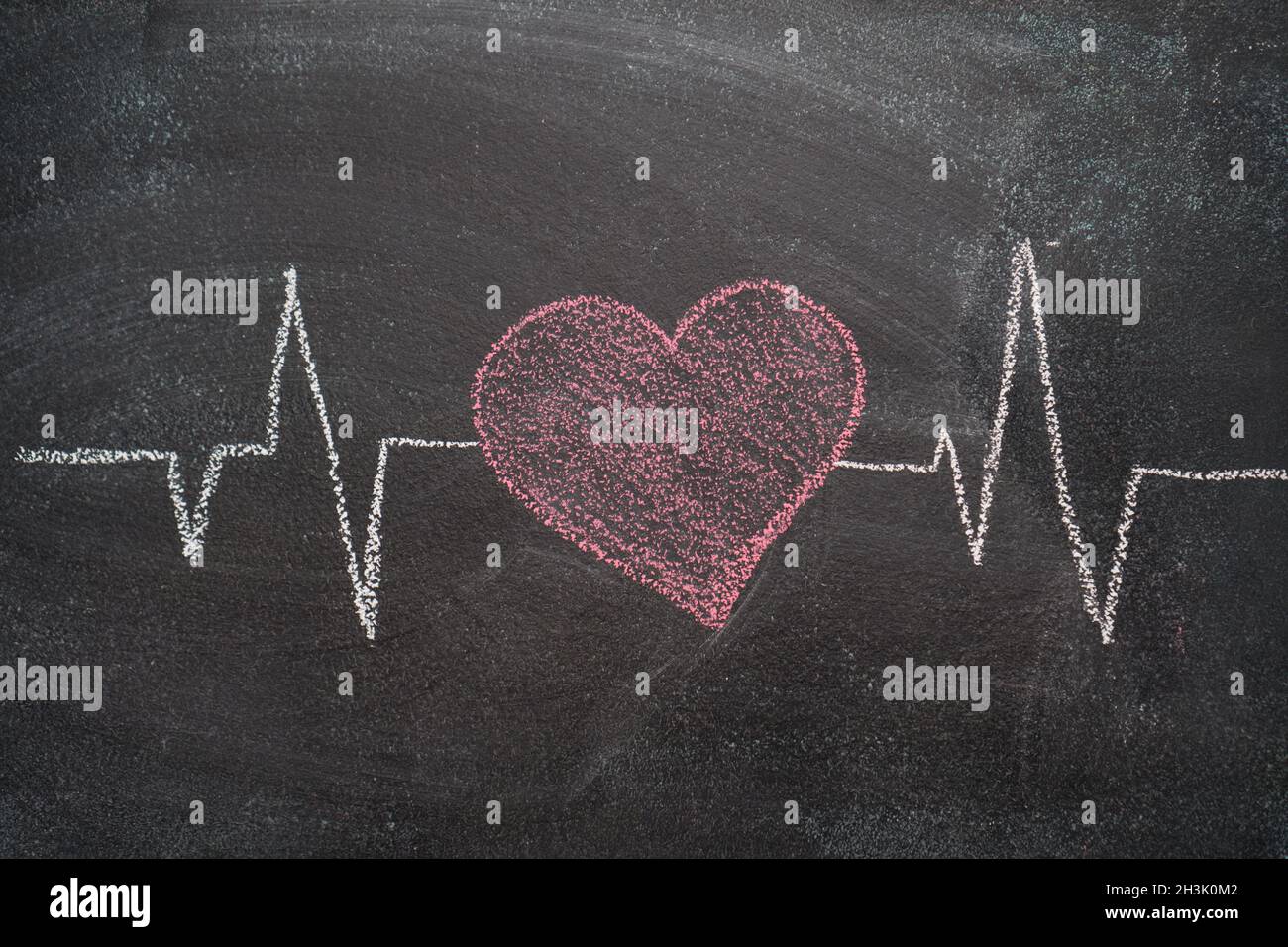 Heartbeat character and design on black chalkboard Stock Photo