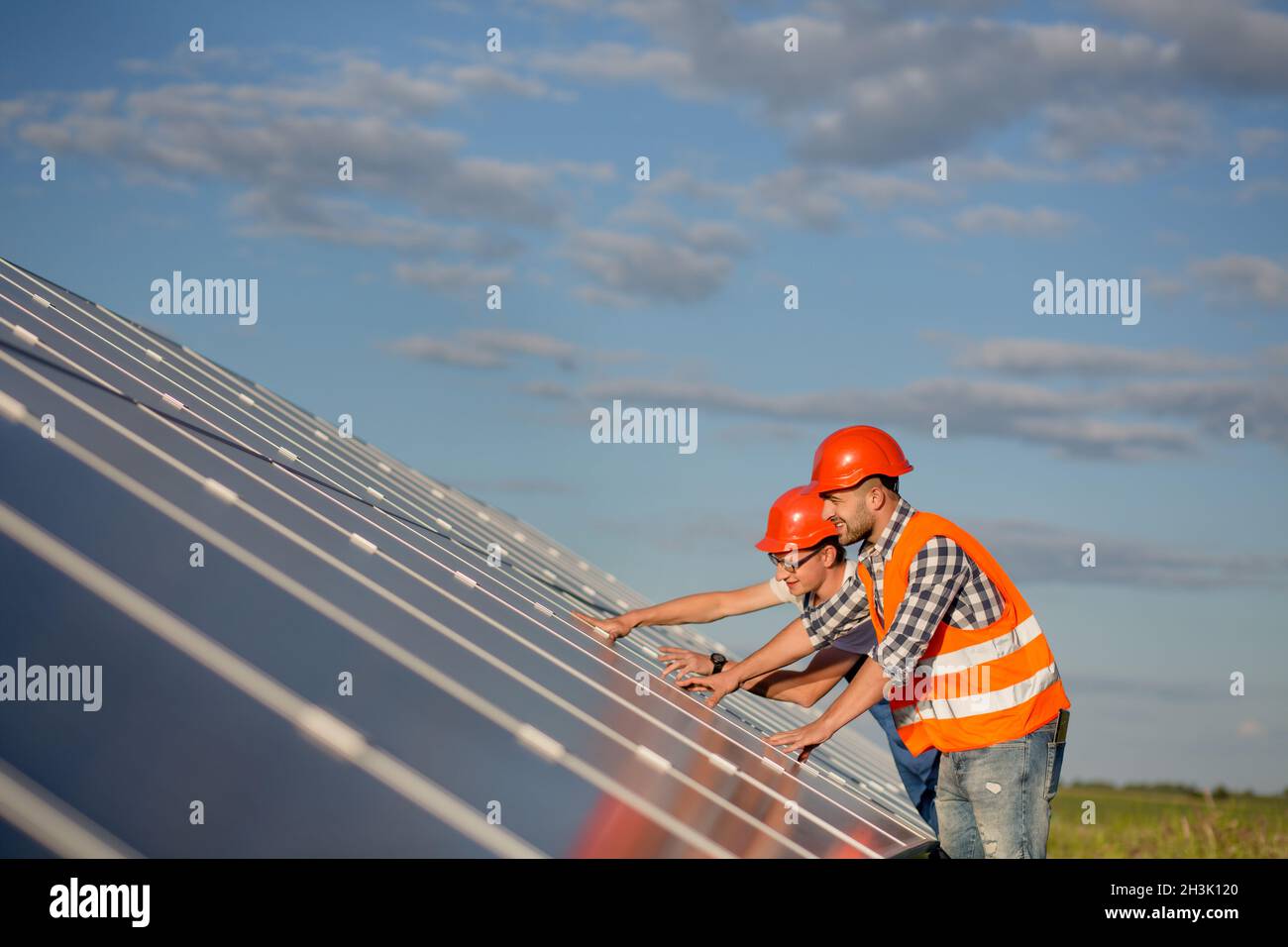Engineers maintaining solar panels in the field. Stock Photo