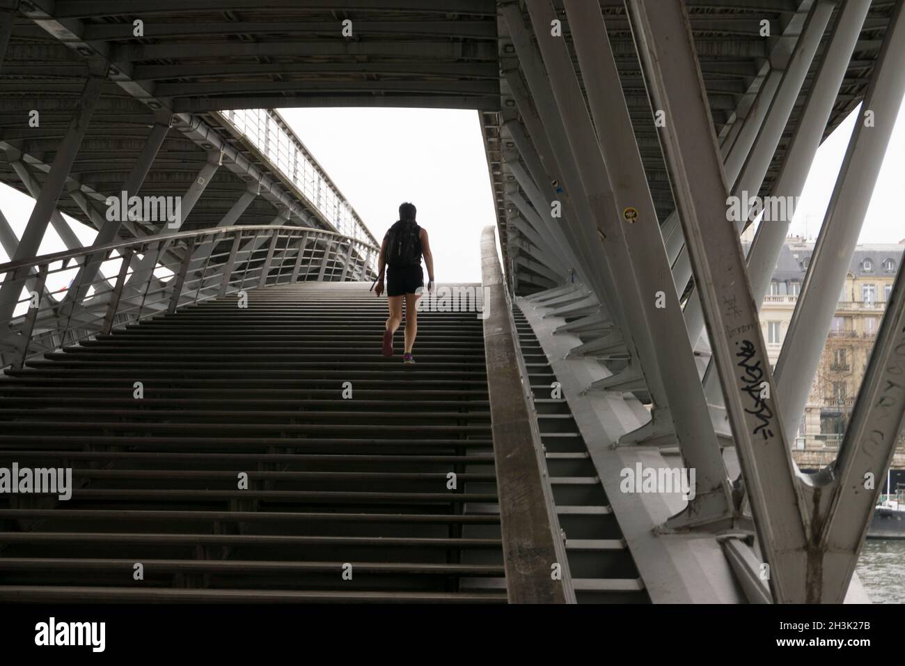 Paris, France. Lone person walking up steps of Passerelle Léopold-Sédar-Senghor Stock Photo