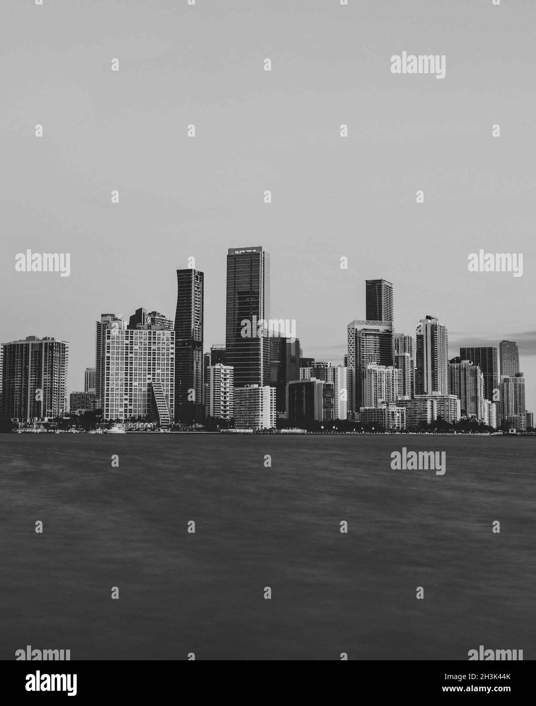 Vertical grayscale shot of a city buildings Stock Photo - Alamy