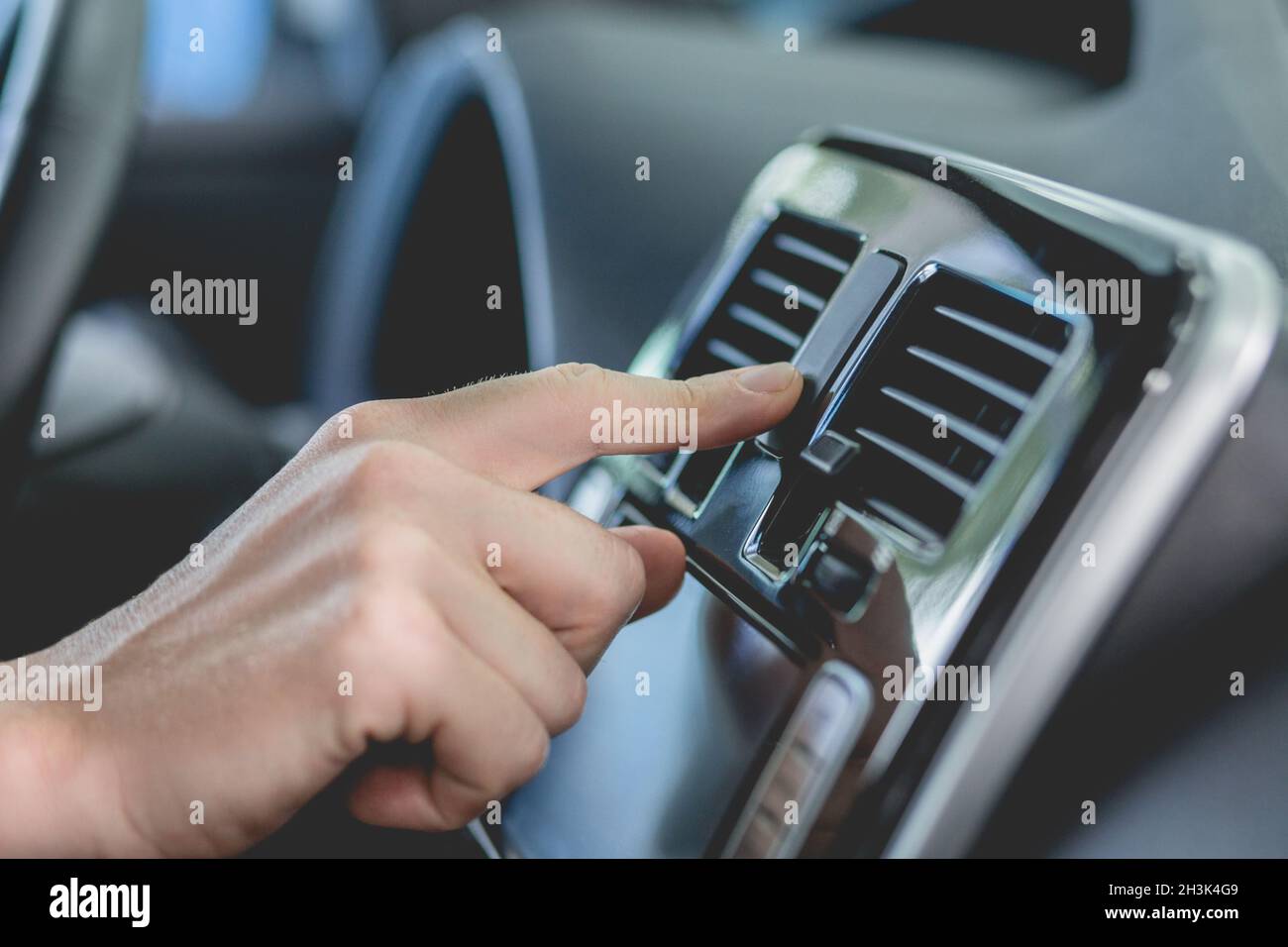 Close up view of finger pushing buttons in new car. Stock Photo
