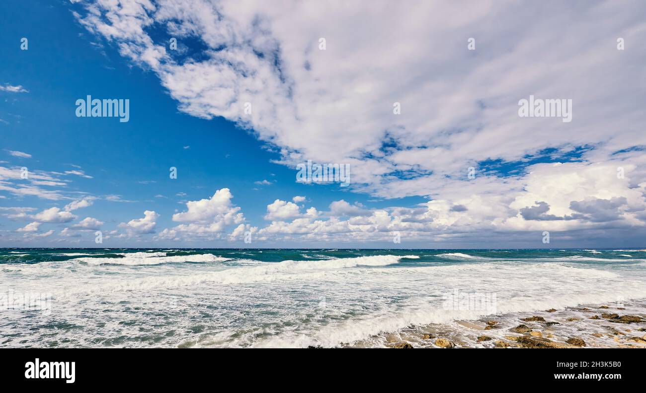 Ocean with waves and blue sky with clouds Stock Photo - Alamy