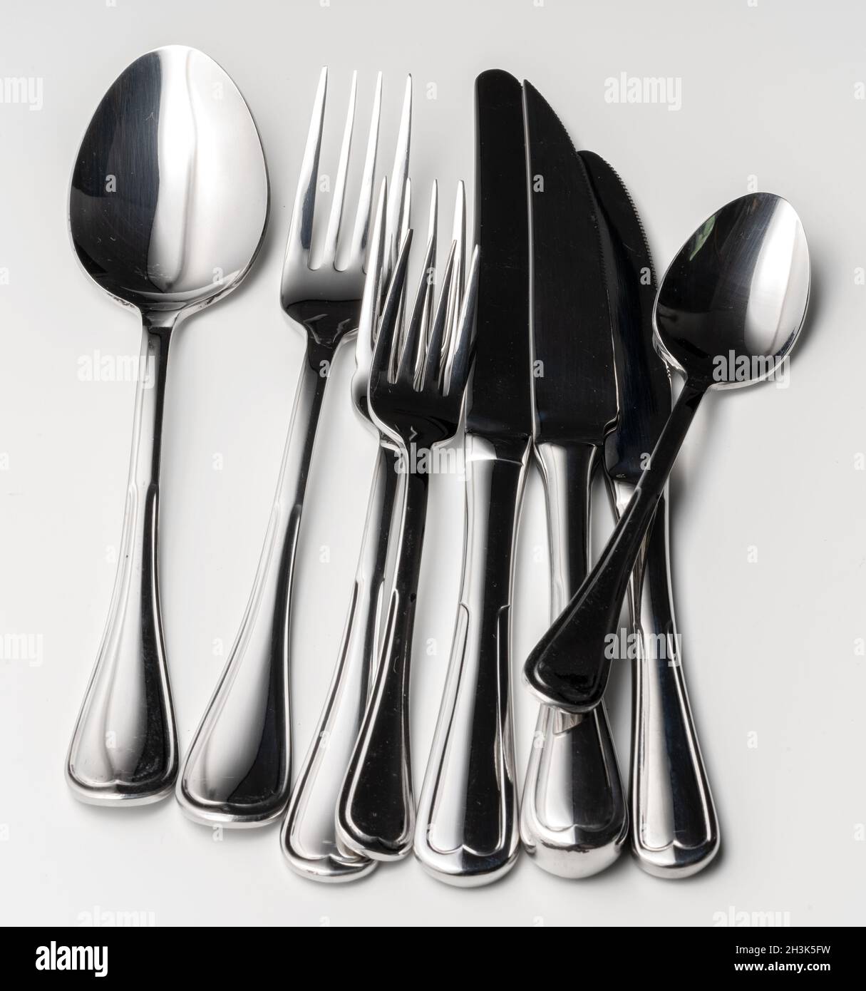 Set of silver cutlery on a white background Stock Photo Alamy