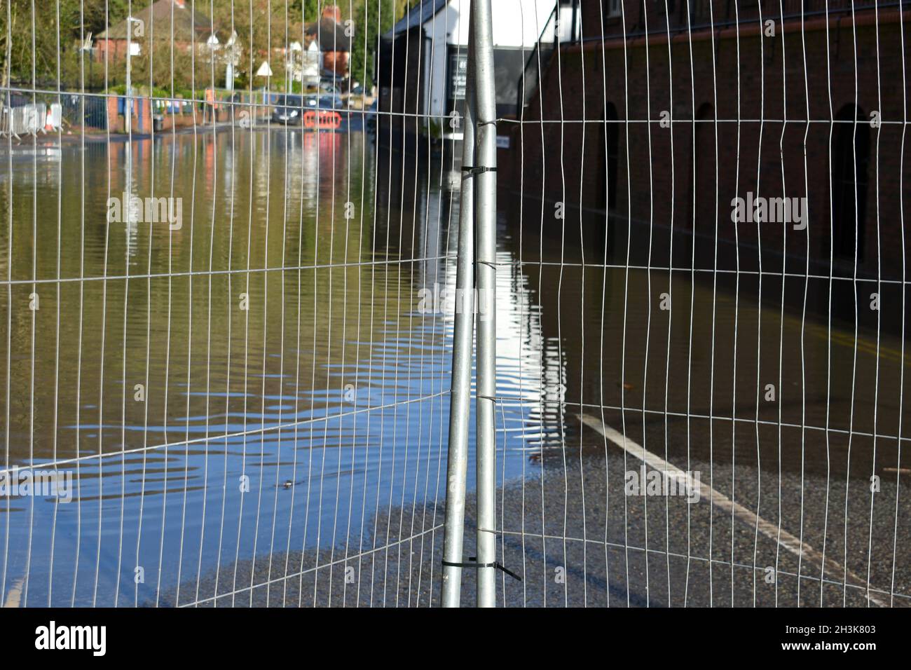 close up of metal gates preventing access to the flooded roads ahead ...