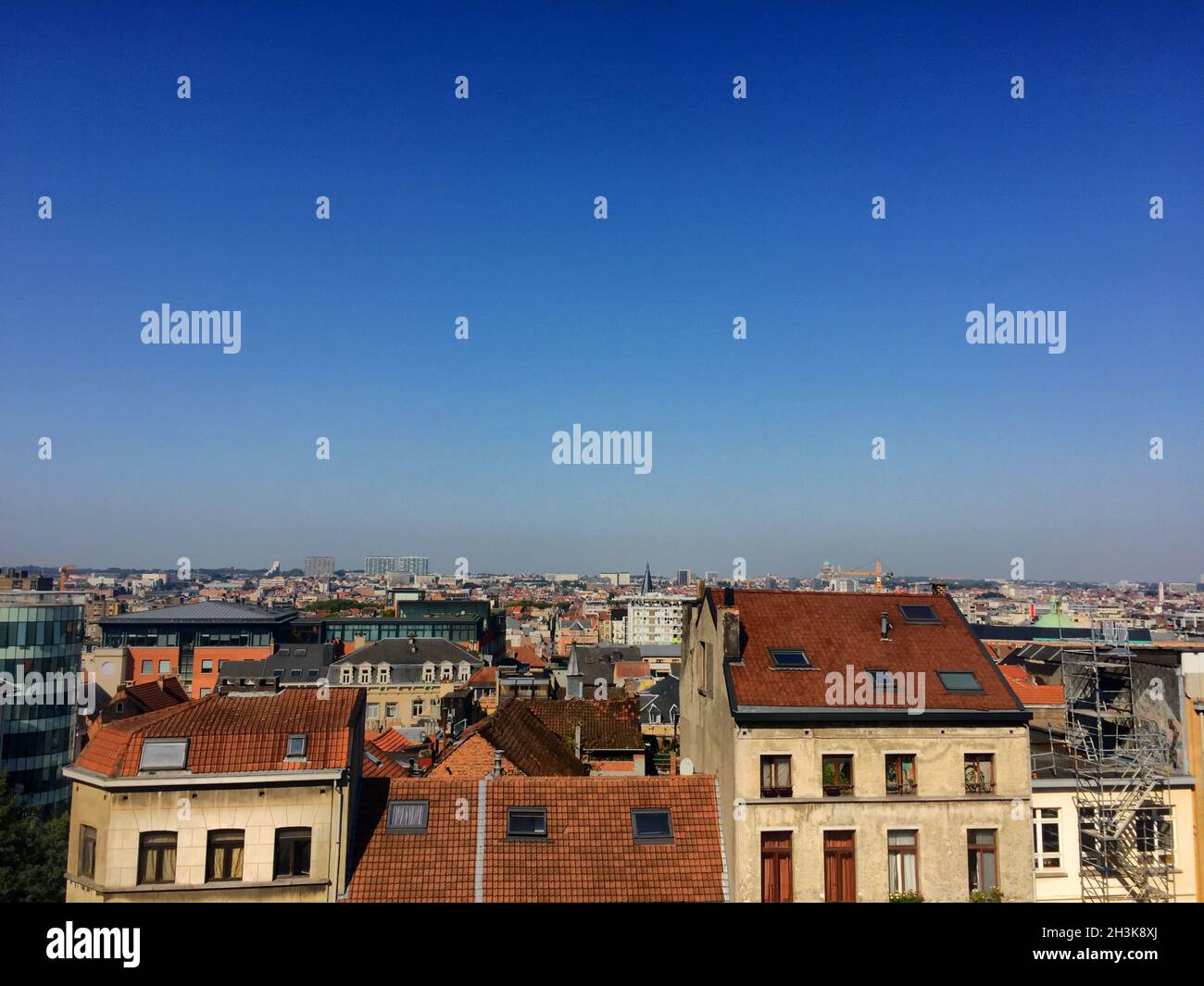 Colorful rooftops in the city under a clear blue sky Stock Photo