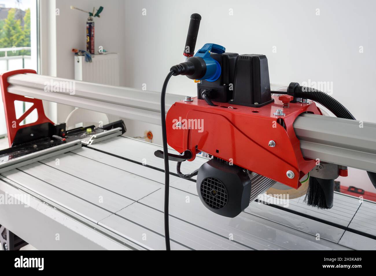 Cutter machine for ceramic tiles. A flat during renovation. Stock Photo