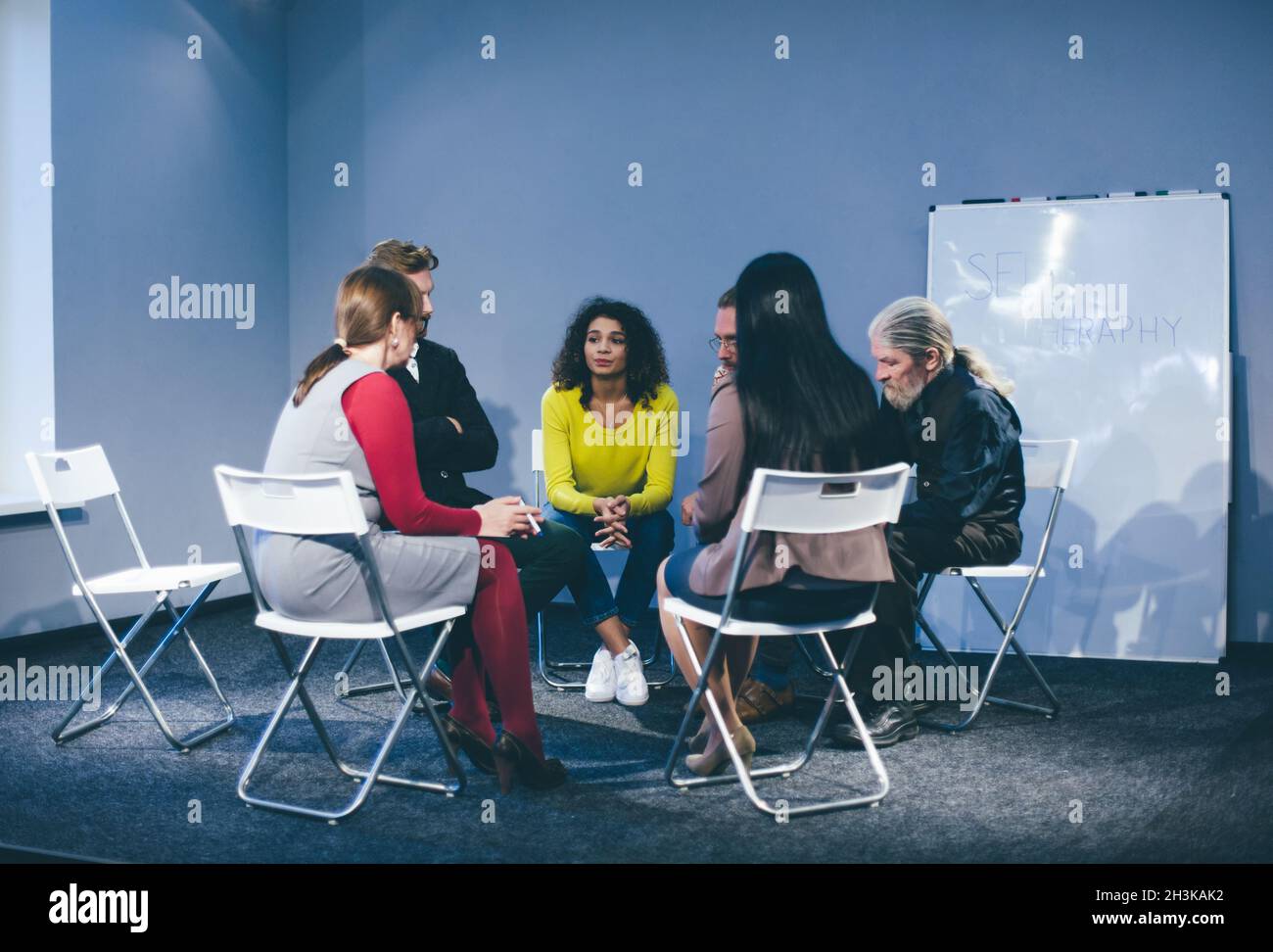 Large group of people having a counseling session. Stock Photo