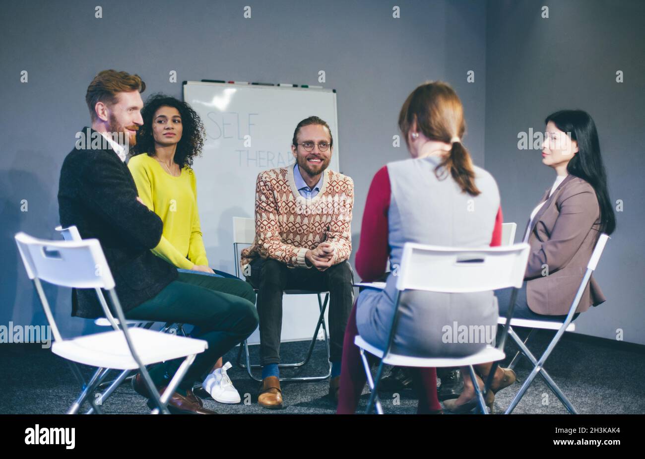 Large group of people having a counseling session. Stock Photo