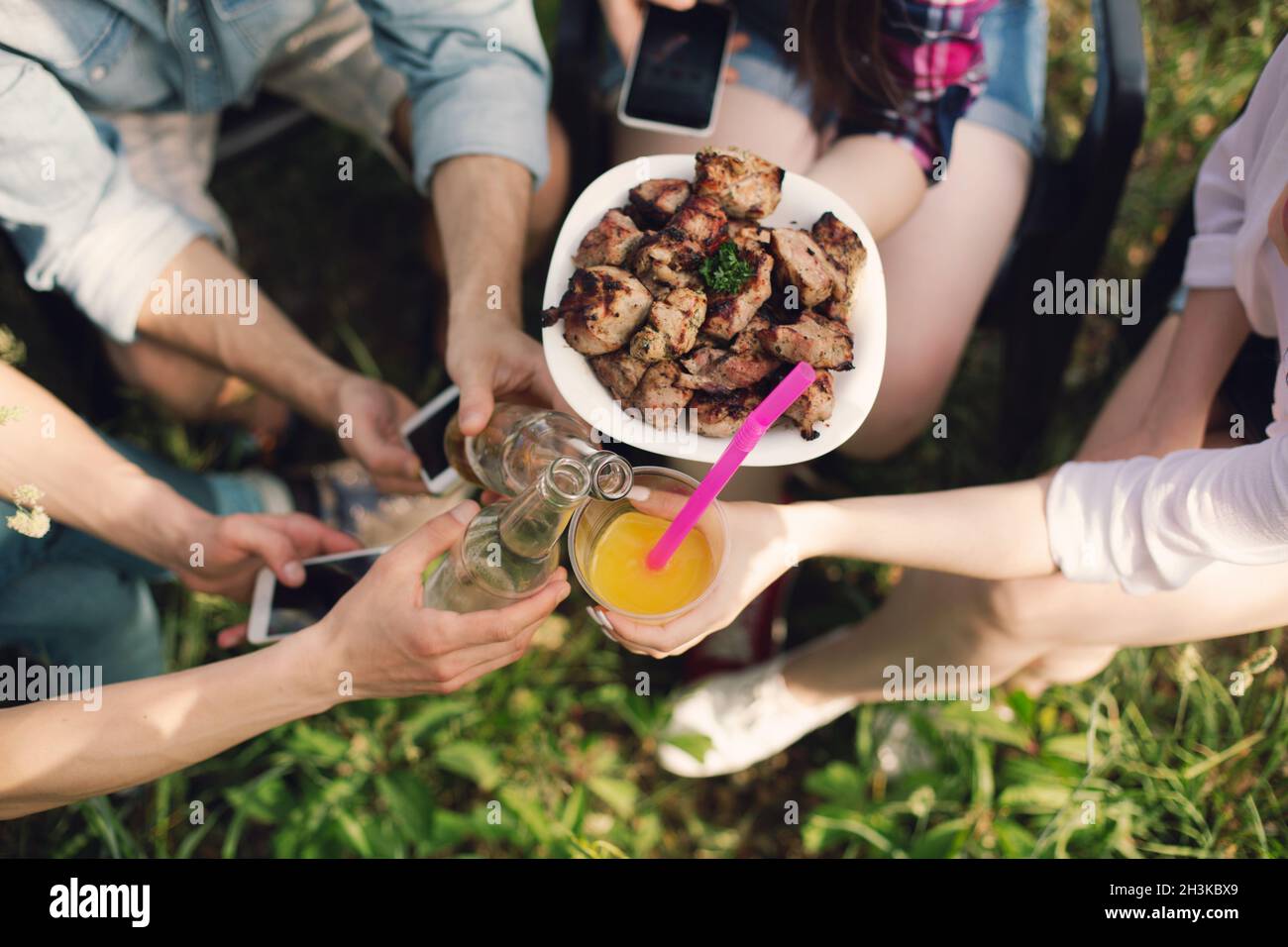 Group of friends having picnic in park hi res stock photography and