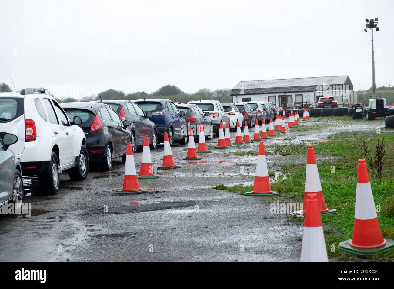 People queuing in row line queue of cars to get coronavirus Pfizer Covid  vaccinations booster jab at Carmarthen showground testing centre in Wales UK Stock Photo