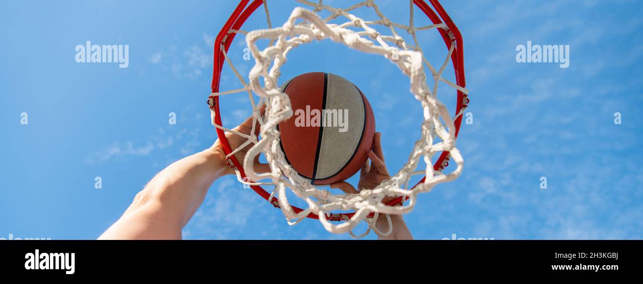 hand and basketball. dunk in basket. slam dunk in motion. professional player. Stock Photo