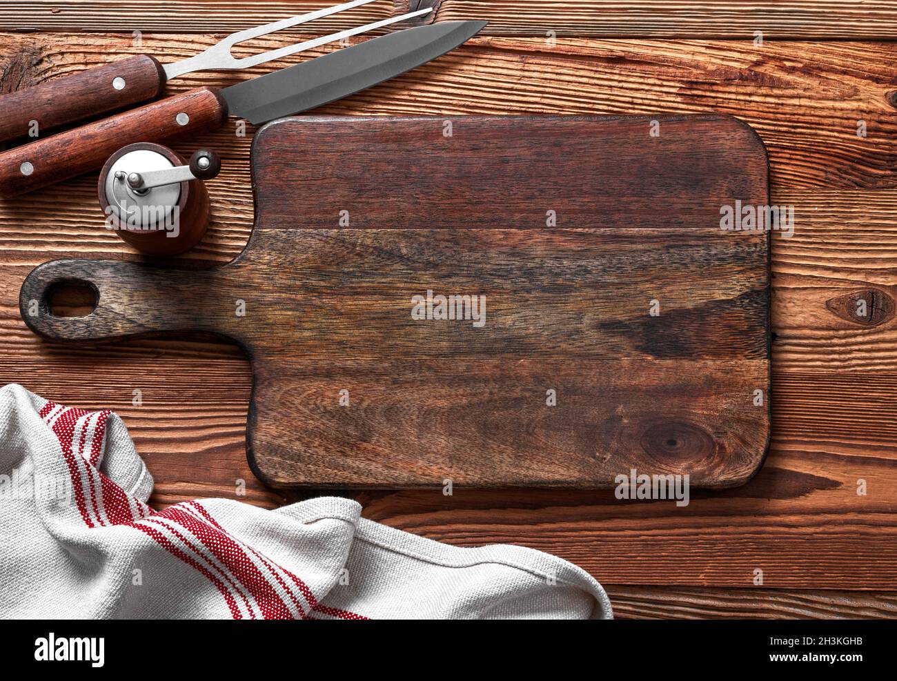 Empty cutting board on a wood table Stock Photo