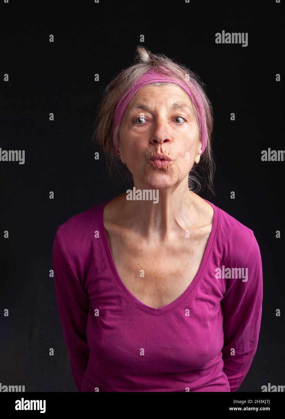 Happy smiling in her seventy-five year old lady Stock Photo